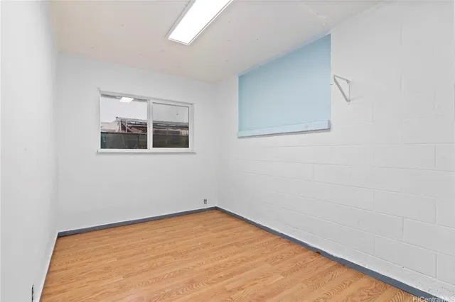a view of a room with a wooden floor and a window
