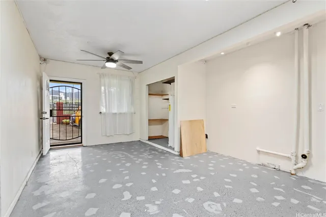 an empty room with closet and windows