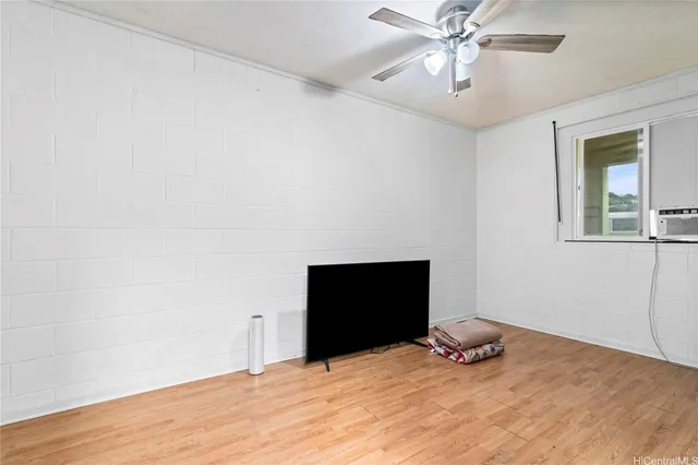 a room with a bed and a ceiling fan