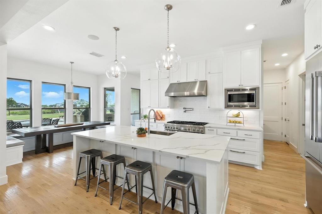 148 Overlook Drive Aledo, TX 76008 - Photo 11 of 40 a large kitchen with kitchen island a large island in it