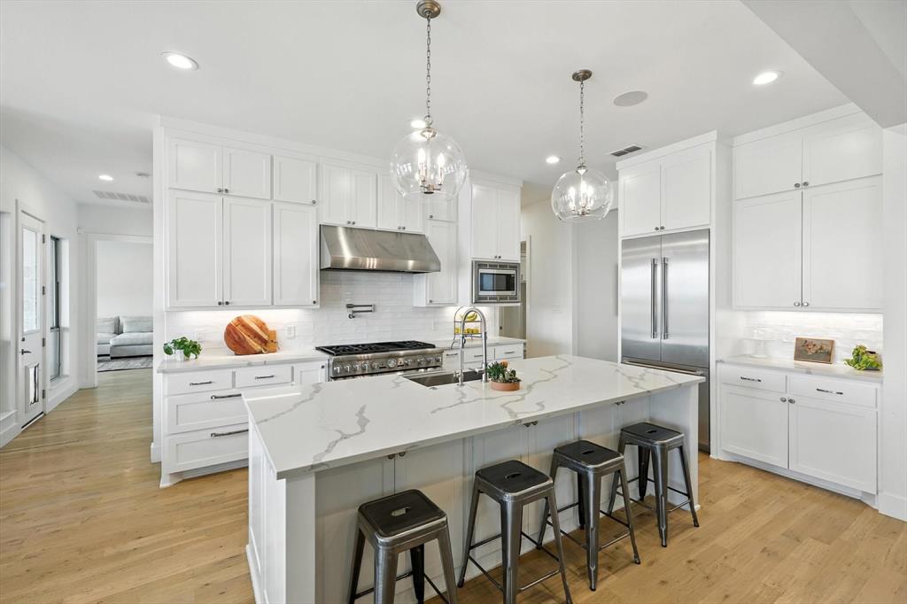 148 Overlook Drive Aledo, TX 76008 - Photo 13 of 40 a kitchen with kitchen island granite countertop a sink a center island and cabinets