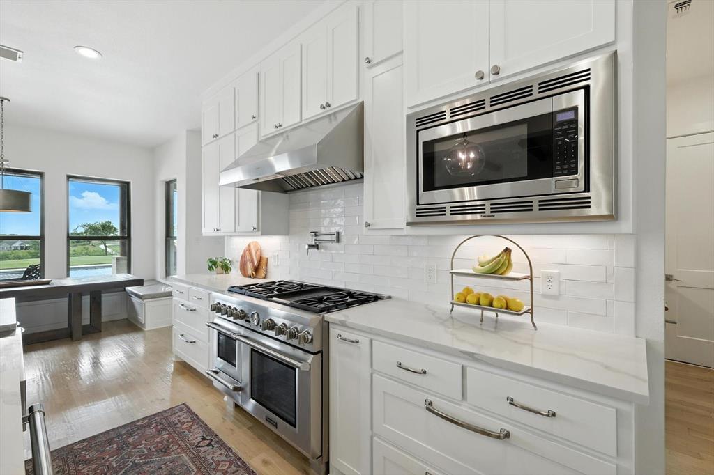 148 Overlook Drive Aledo, TX 76008 - Photo 15 of 40 a kitchen with a stove and a microwave