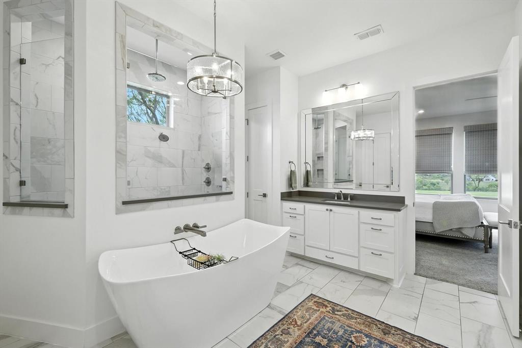 148 Overlook Drive Aledo, TX 76008 - Photo 21 of 40 a bathroom with a sink a bathtub a mirror a vanity and a shower