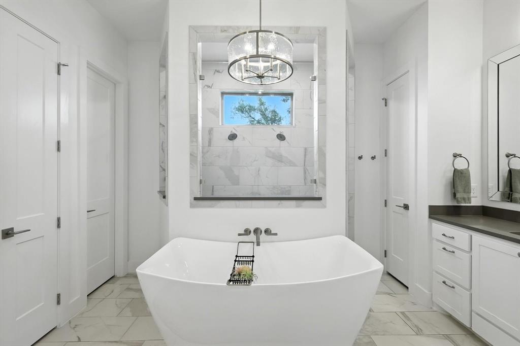 148 Overlook Drive Aledo, TX 76008 - Photo 22 of 40 a bathroom with a bathtub a sink and a window