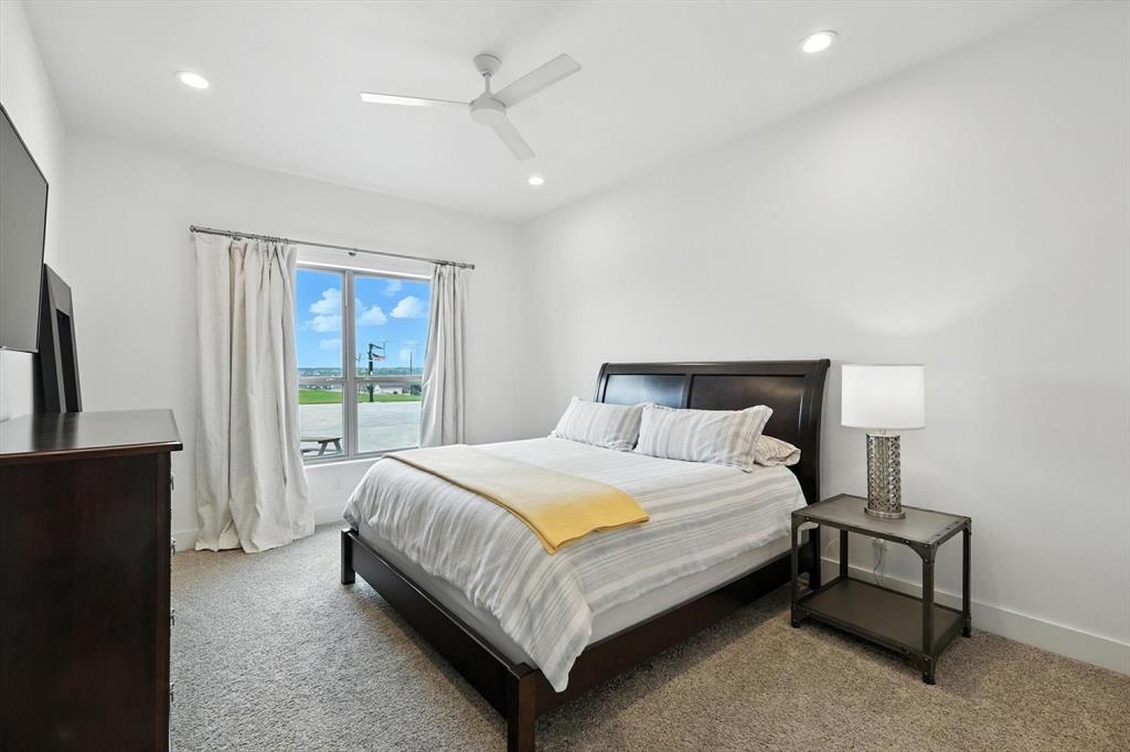 148 Overlook Drive Aledo, TX 76008 - Photo 25 of 40 a bedroom with a bed lamp and a dresser