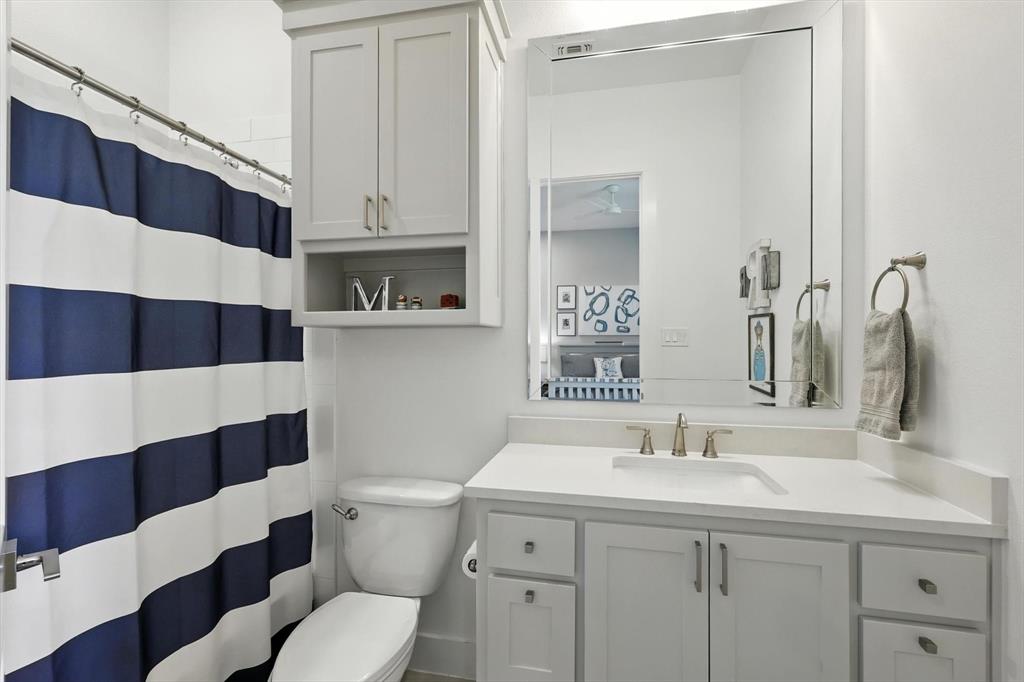 148 Overlook Drive Aledo, TX 76008 - Photo 30 of 40 a bathroom with a sink a toilet a shower and a mirror