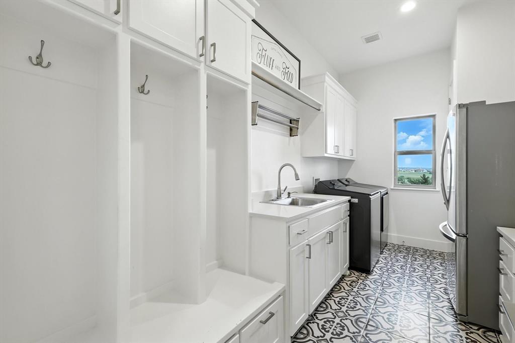 148 Overlook Drive Aledo, TX 76008 - Photo 32 of 40 a kitchen with a sink a refrigerator a stove and cabinets