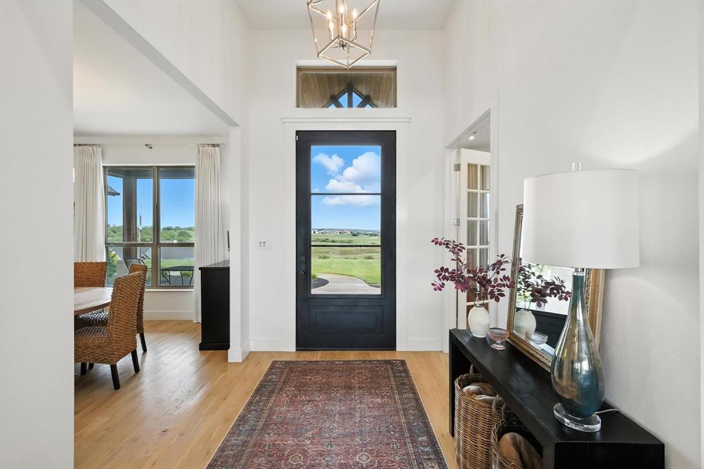 148 Overlook Drive Aledo, TX 76008 - Photo 4 of 40 a living room with furniture and a chandelier