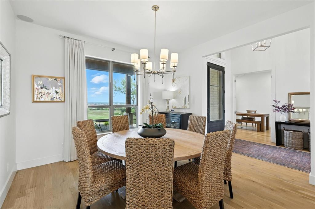 148 Overlook Drive Aledo, TX 76008 - Photo 5 of 40 a dining room with furniture a chandelier and wooden floor