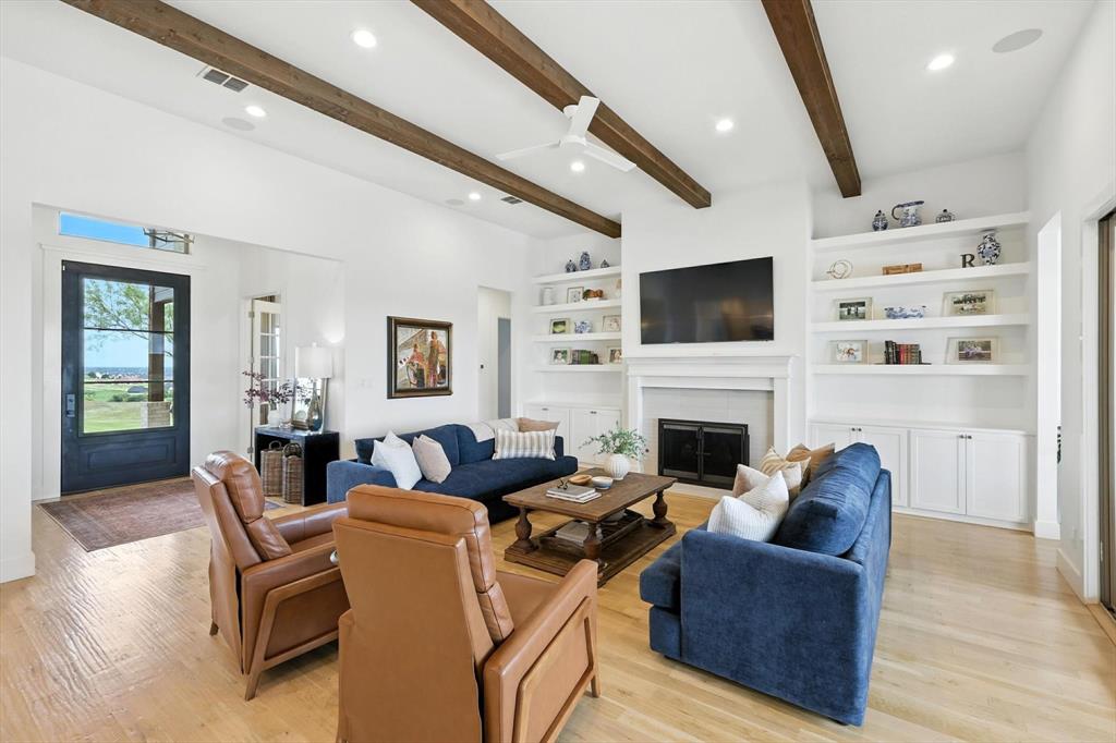 148 Overlook Drive Aledo, TX 76008 - Photo 8 of 40 a living room with furniture a fireplace and a flat screen tv