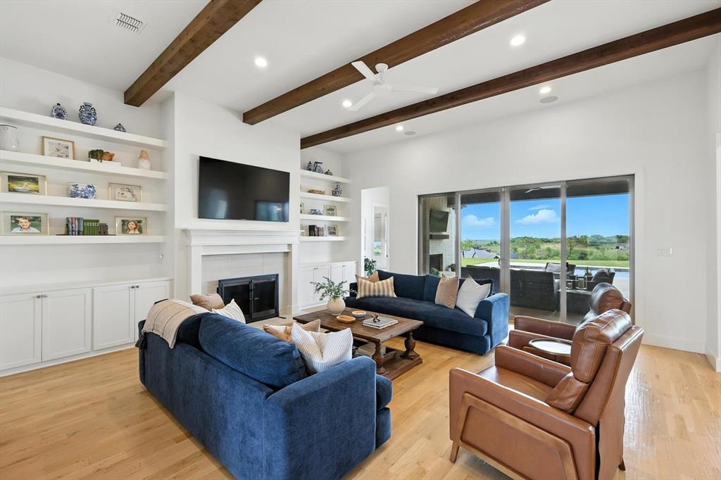148 Overlook Drive Aledo, TX 76008 - Photo 9 of 40 a living room with furniture a fireplace and a flat screen tv