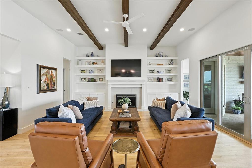 148 Overlook Drive Aledo, TX 76008 - Photo 10 of 40 a living room with furniture a flat screen tv and a fireplace