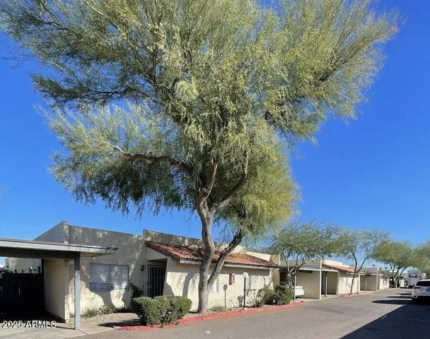 a view of a street with a house in front of it