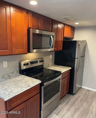 a kitchen with a refrigerator stove and microwave