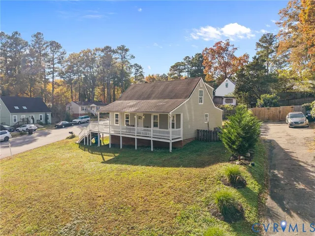 a view of a house with swimming pool next to a yard