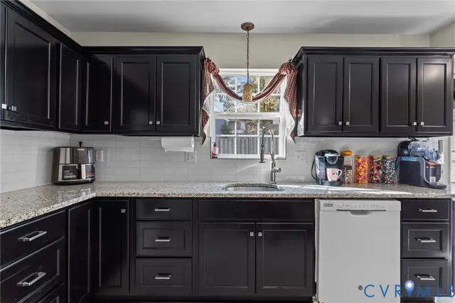 a kitchen with stainless steel appliances granite countertop a sink a stove and cabinets