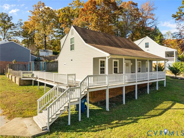 a view of a house with backyard porch and sitting area