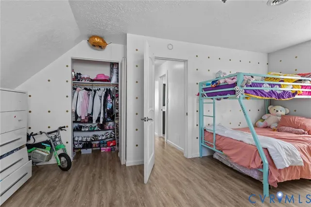 a bedroom with furniture and a wooden floor