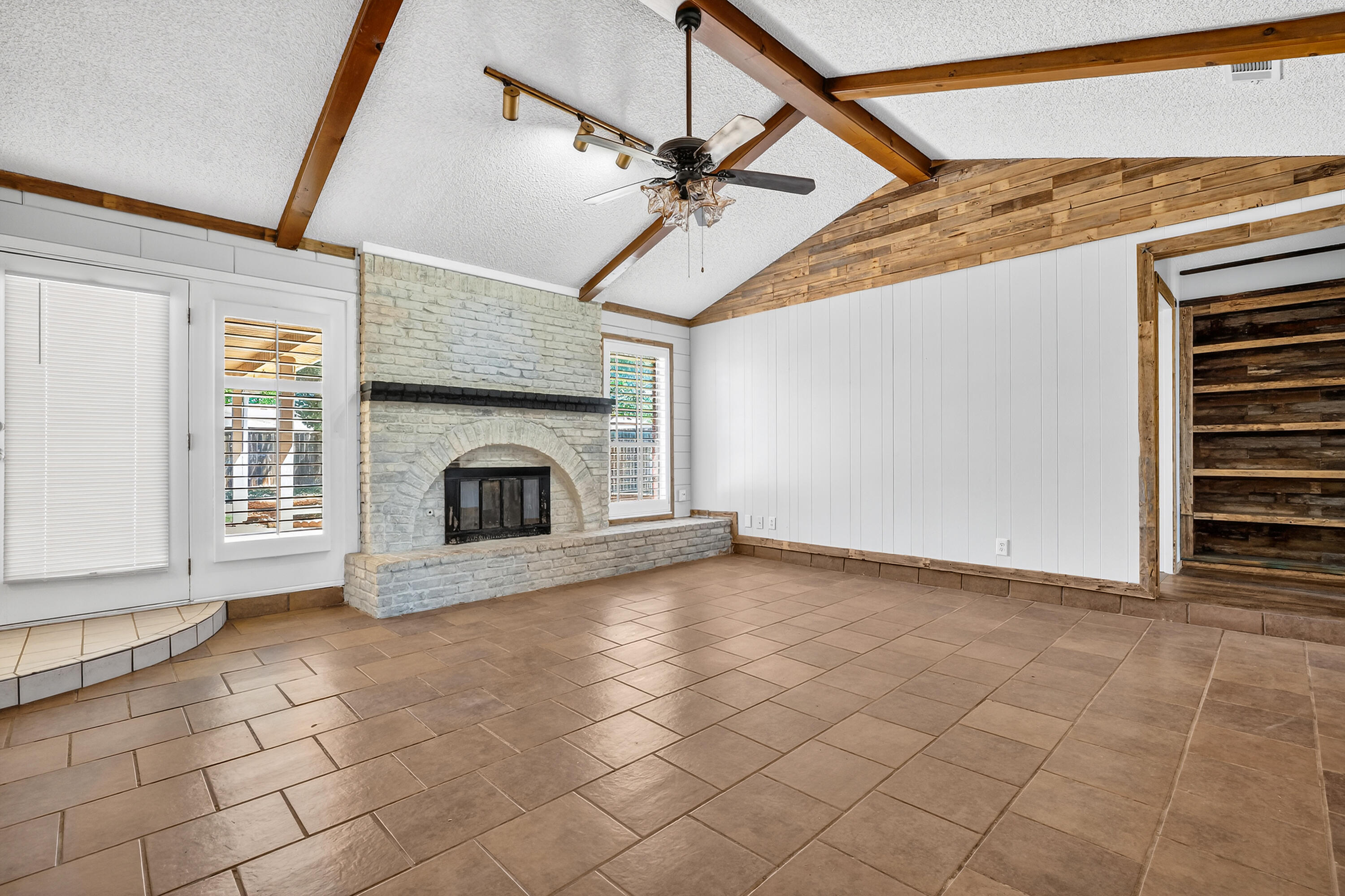 5236 91st Street Lubbock, TX 79424 - Photo 3 of 23 a view of an empty room with a fireplace and a window