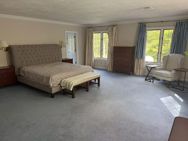 a bedroom with a bed and a chair