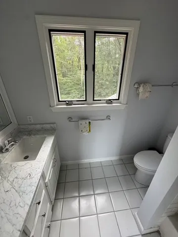 a living room with furniture gym equipment and a window