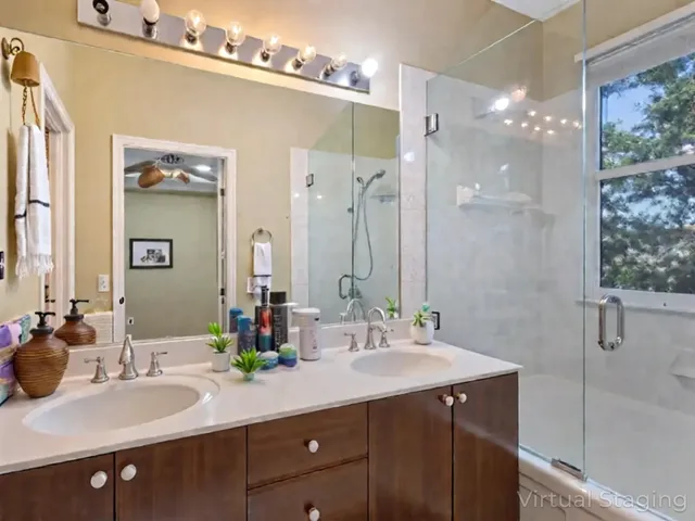 a bathroom with a double vanity sink mirror and double