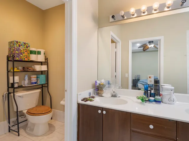 a bathroom with a toilet a sink and mirror