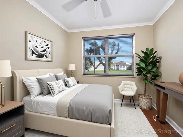 a bedroom with a bed and a painting on the wall