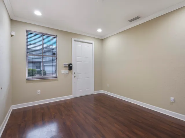 a view of wooden floor and windows in a room