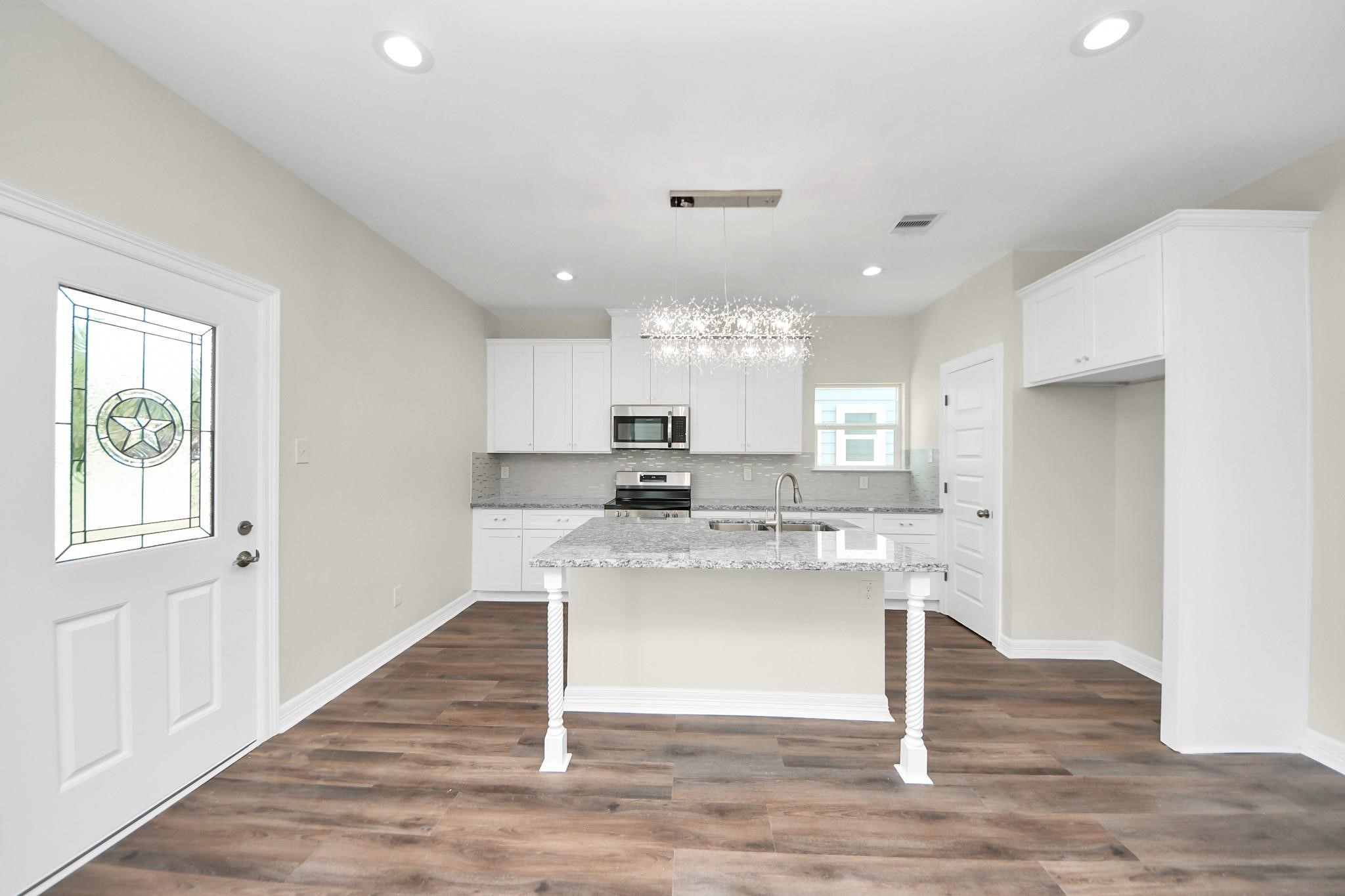 422 North 4th Street Beasley, TX 77417 - Photo 8 of 30 a kitchen with kitchen island sink stove and refrigerator