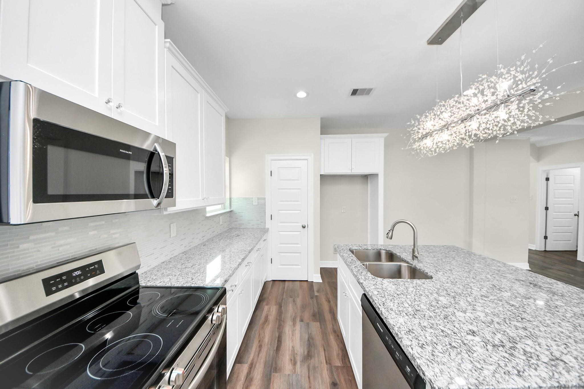 422 North 4th Street Beasley, TX 77417 - Photo 10 of 30 a kitchen with a sink stainless steel appliances and cabinets