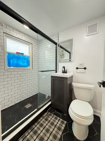 a bathroom with a toilet a sink and a shower