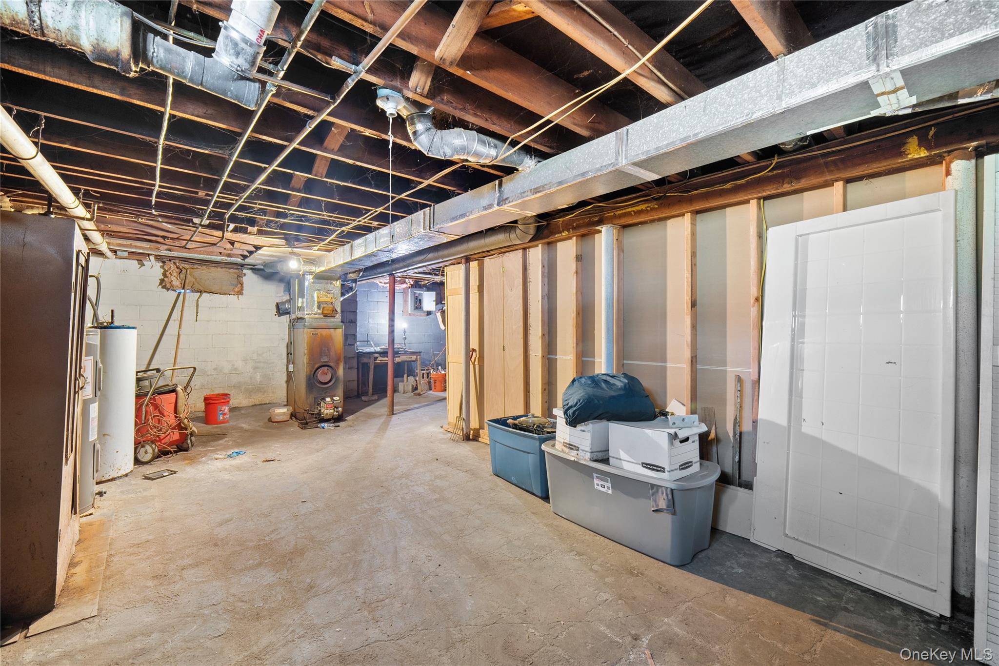 1739 Harrison Avenue Bay Shore, NY 11706 - Photo 10 of 15 a storage room with water heater and racks on the wall