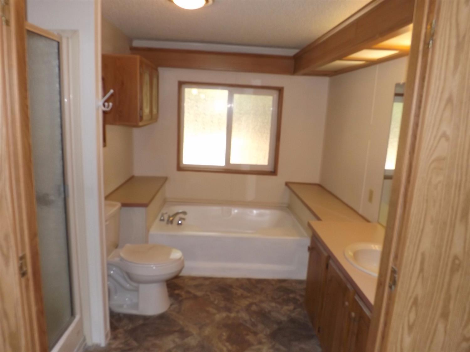 1846 Queens Branch Road Rogue River, OR 97537 - Photo 14 of 21 a bathroom with a sink a toilet and a bathtub