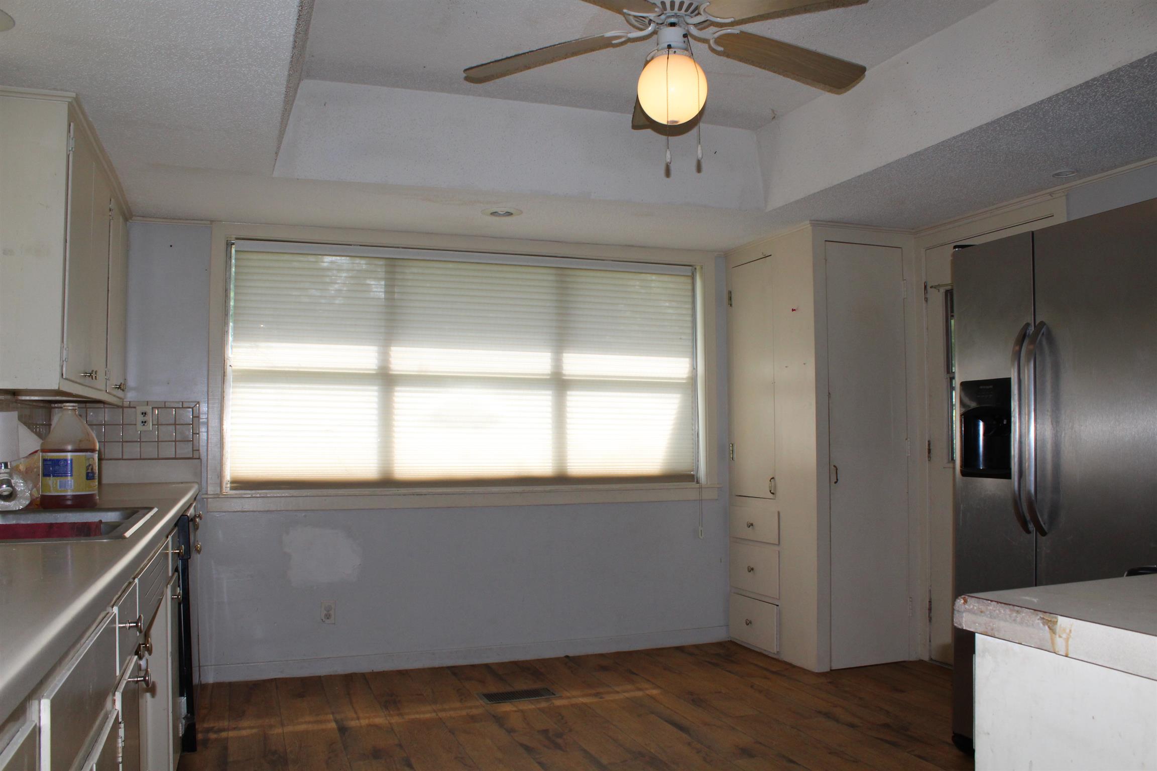 932 CCC Road McEwen, TN 37101 - Photo 8 of 30 a view of a kitchen with a sink dishwasher and wooden floor