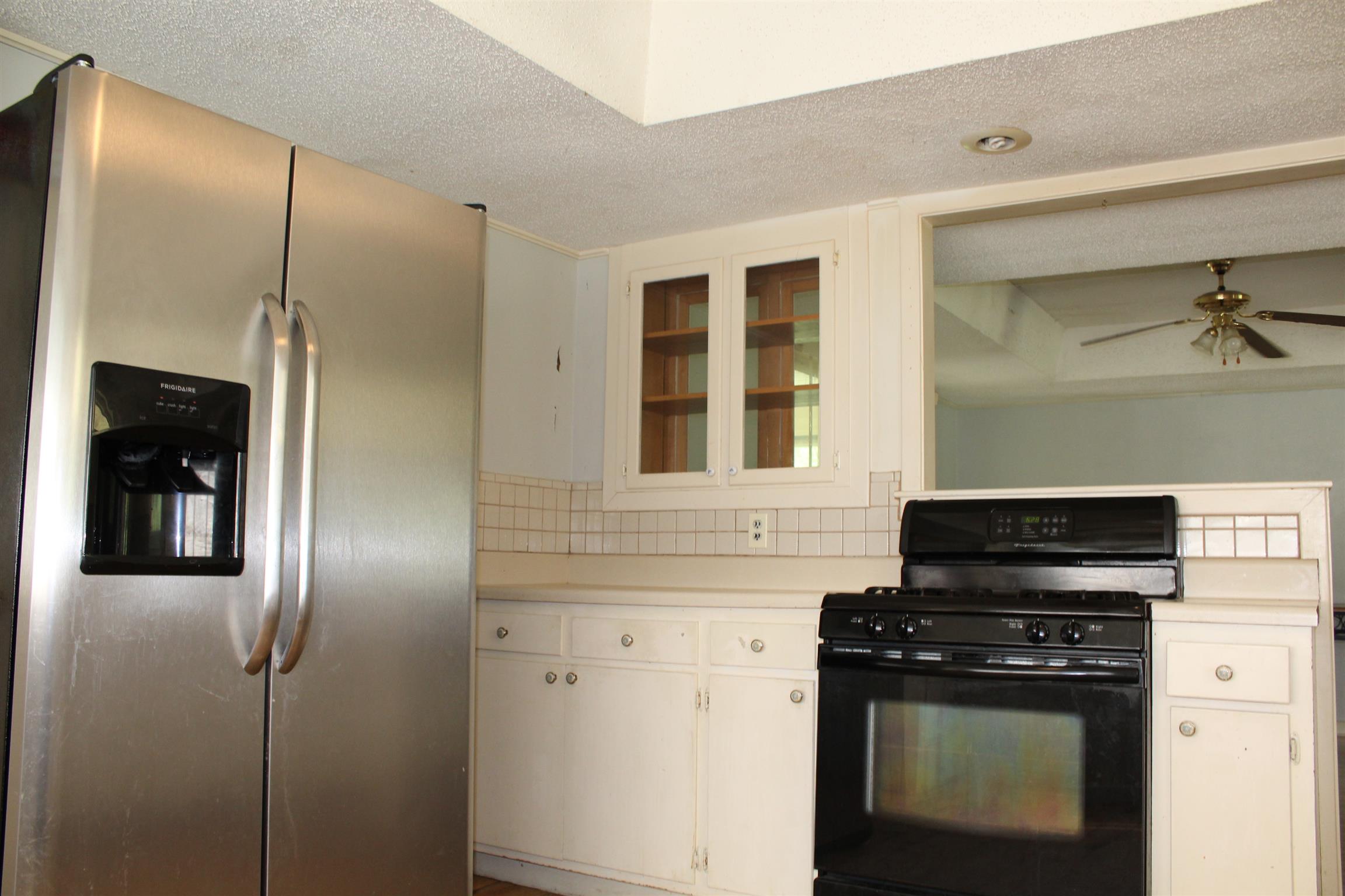 932 CCC Road McEwen, TN 37101 - Photo 9 of 30 a kitchen with granite countertop a refrigerator and a stove top oven
