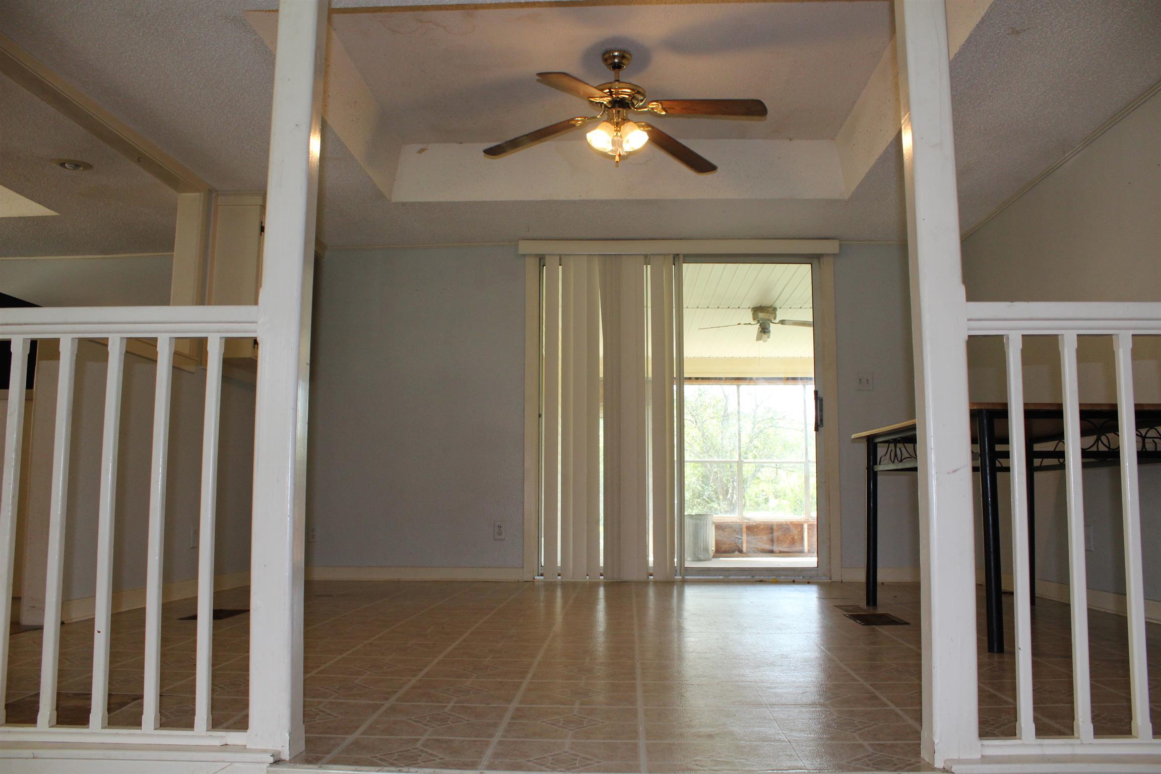 932 CCC Road McEwen, TN 37101 - Photo 10 of 30 a view of empty room with wooden floor and fan