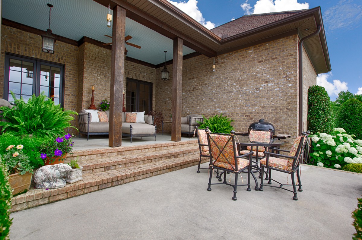 7195 Barker Road Athens, AL 35614 - Photo 5 of 49 a backyard of a house with a table and chairs potted plants