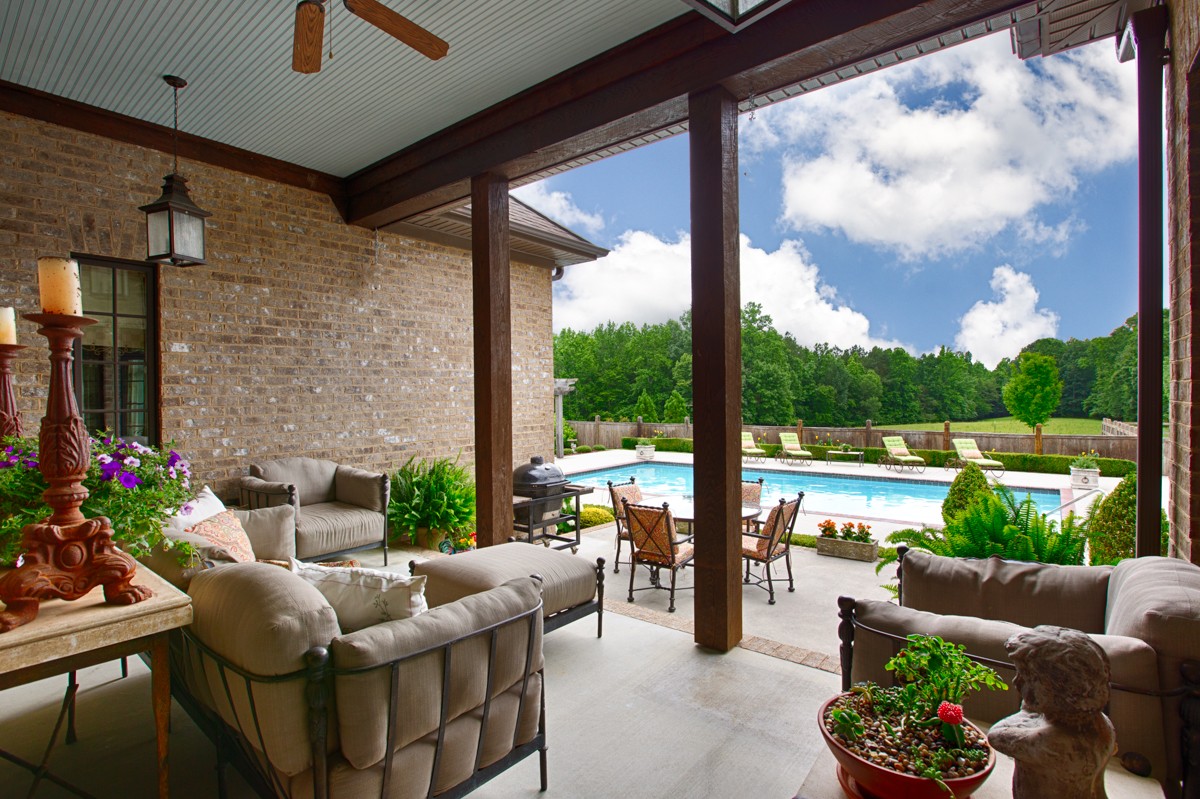 7195 Barker Road Athens, AL 35614 - Photo 6 of 49 a view of a patio with couches chairs and a floor to ceiling window