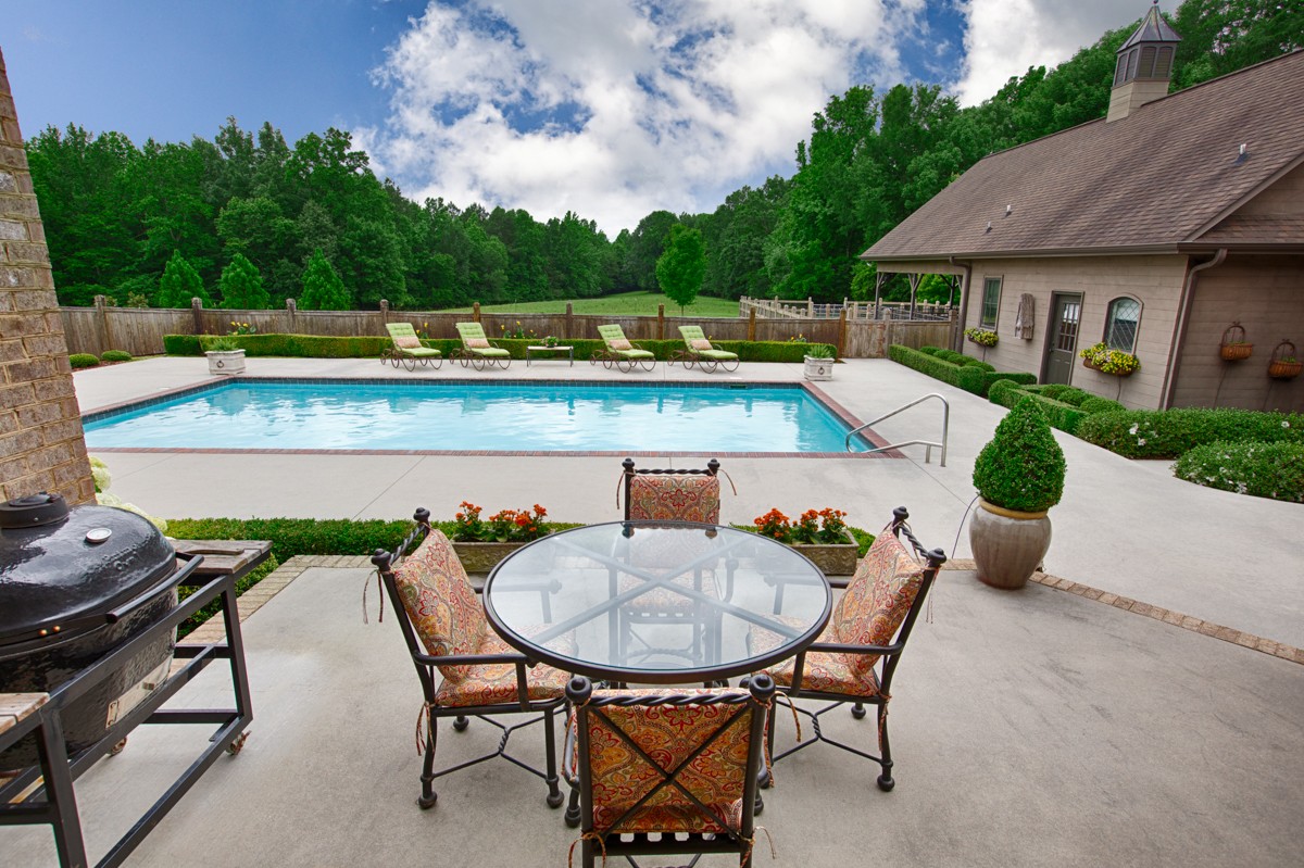 7195 Barker Road Athens, AL 35614 - Photo 7 of 49 a view of deck with table and chairs barbeque oven and plants