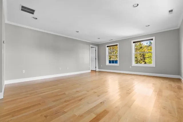 an empty room with windows and entrance