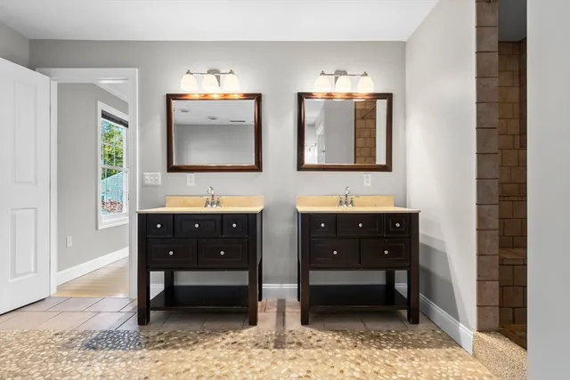 a bathroom with double vanity and a sink