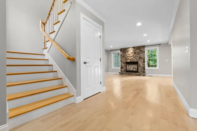 a view of main area with wooden floor fireplace and windows