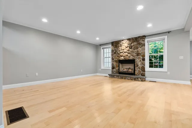 a view of empty room with furniture and a fireplace