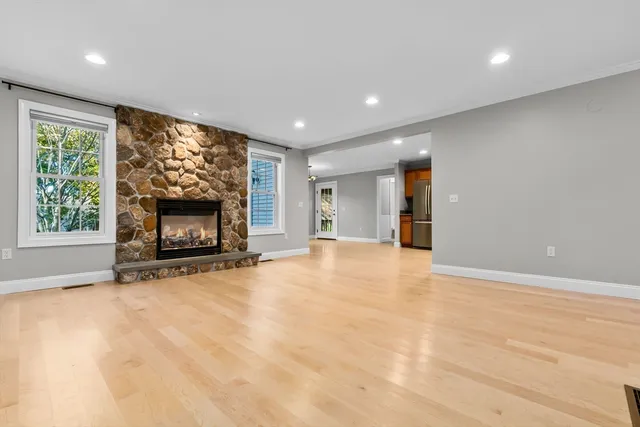 an empty room with furniture and a fireplace