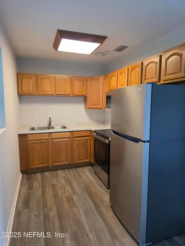 a kitchen with stainless steel appliances a refrigerator and a stove