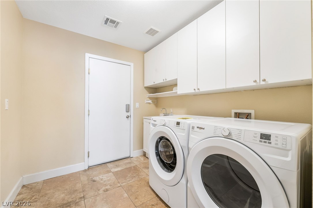 271 Pointe Ranier Avenue Henderson, NV 89012 - Photo 17 of 26 This functional laundry room offers practical convenience for daily chores.