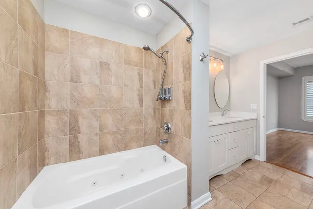 a bathroom with a sink a mirror and a bathtub