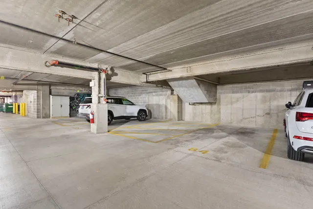 a view of parking garage with cars