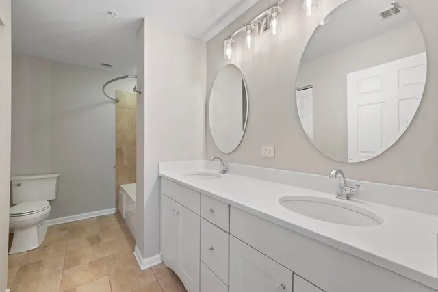 a bathroom with a double vanity sink and a mirror